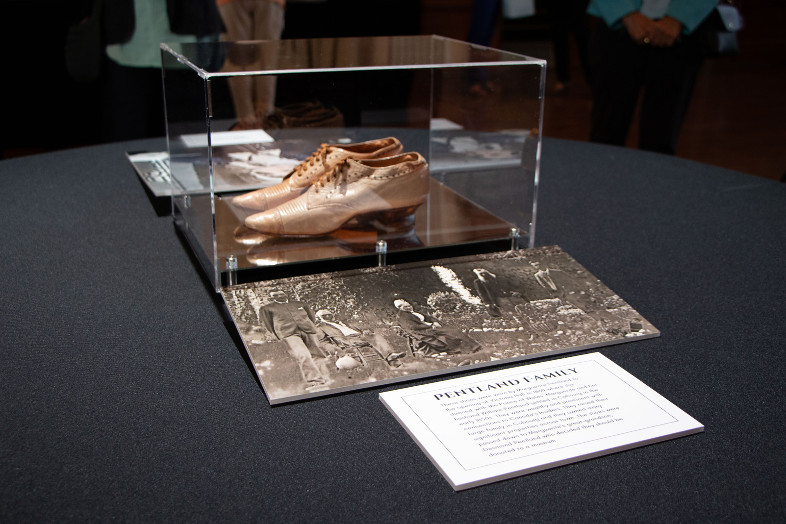 historic shoes displayed in protective box at community event
