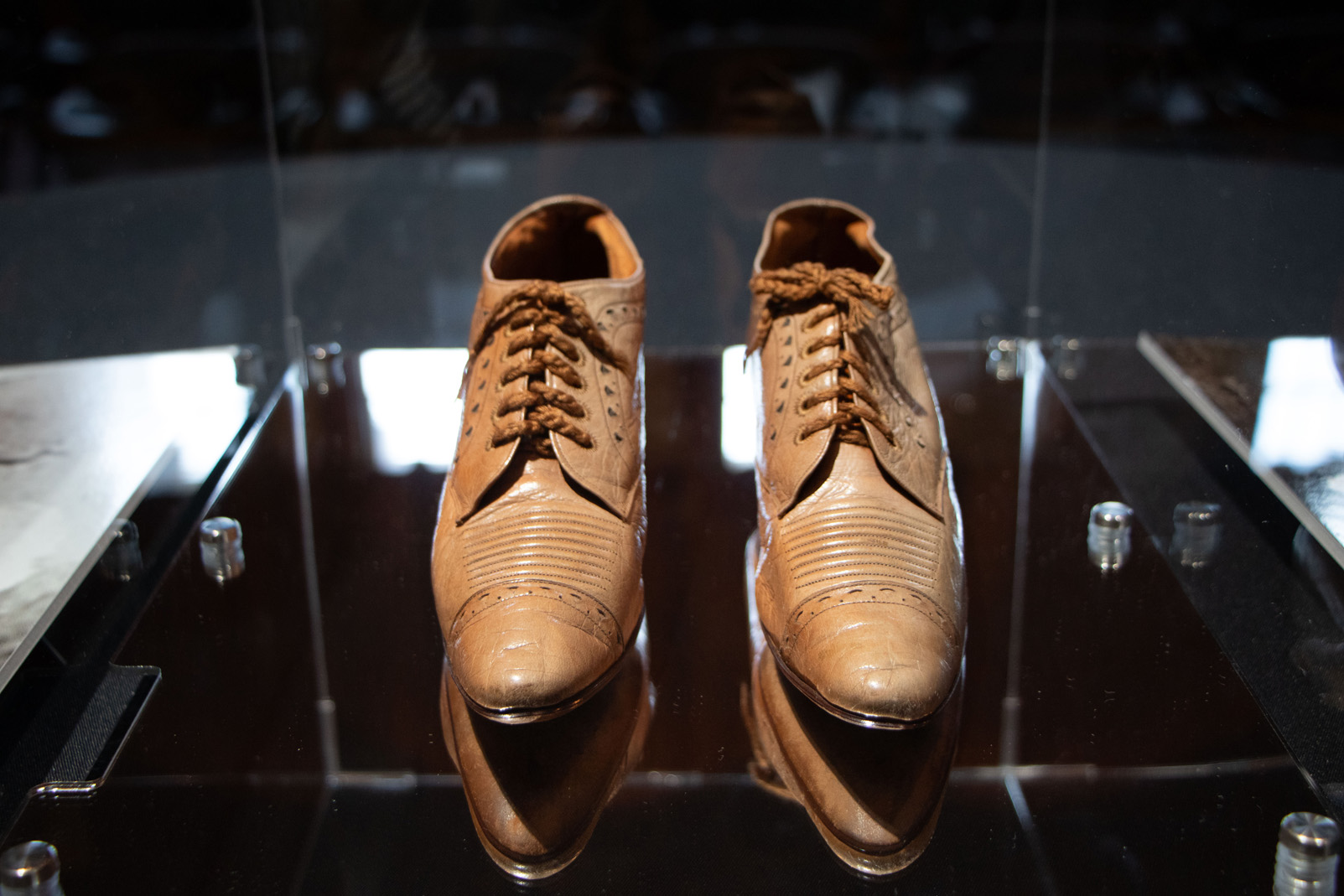 Pair of brown leather shoes displayed in glass case